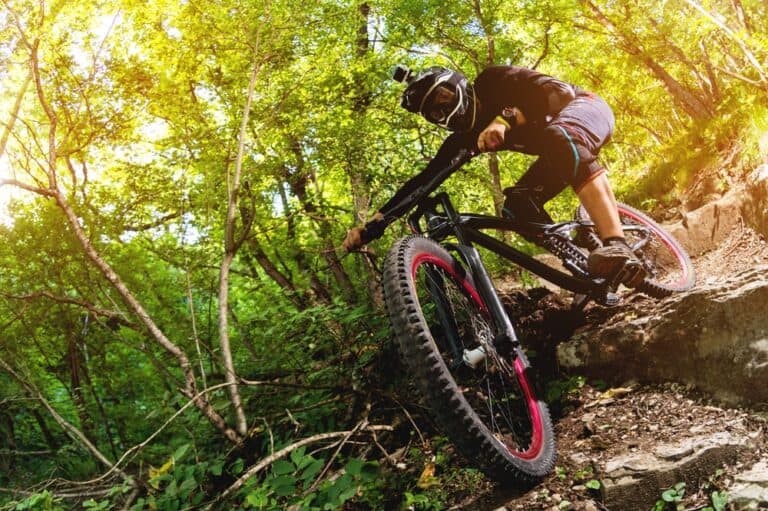 A mountain biker making his way down a mountain trail.