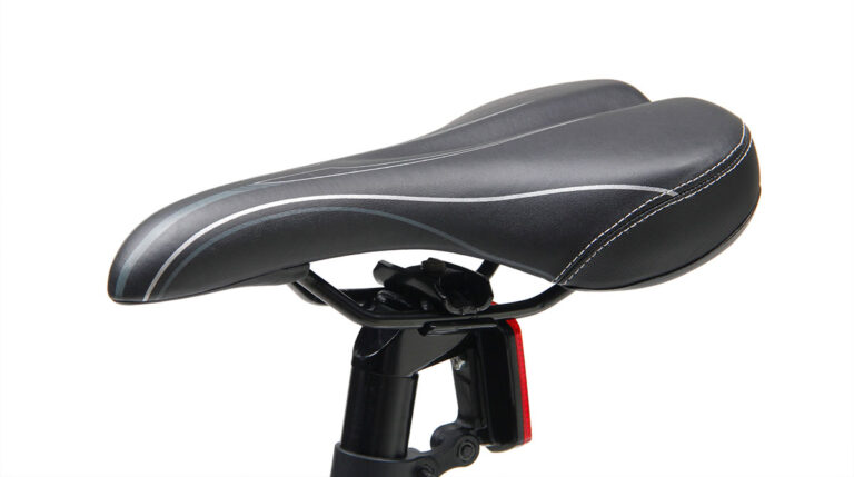 Mountain bike saddle with red light reflector.