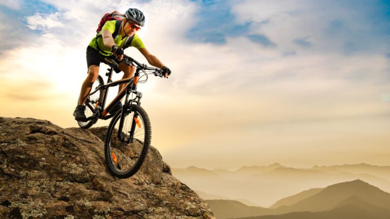 A man on his mountain bike with full gear.