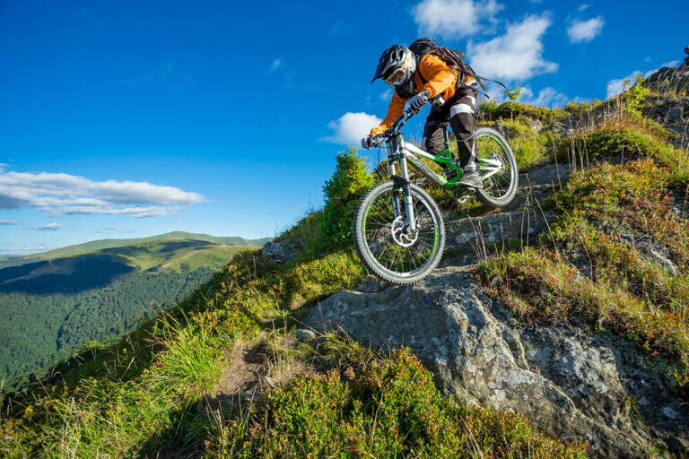 Professional cyclist drifting on a mountain trail.