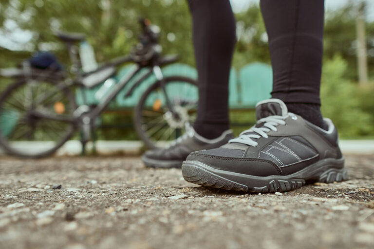 A cyclist with mountain bike shoes.