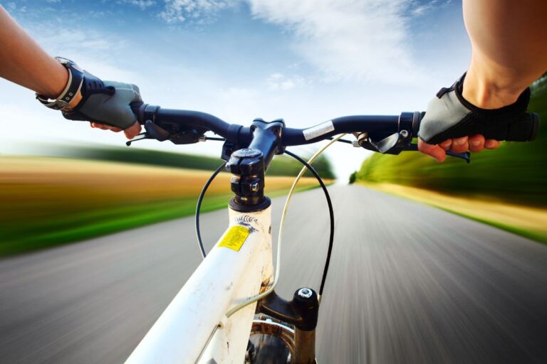 A cyclist on the mountain bike wearing gloves.