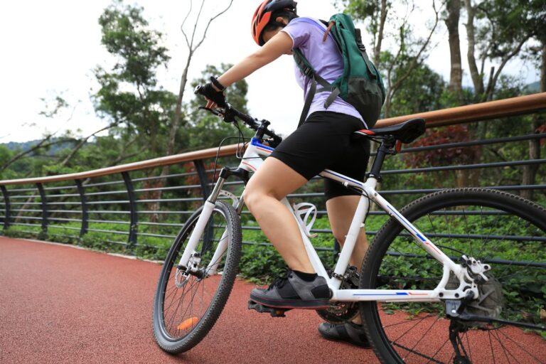 A woman with her mountain bike and bag.