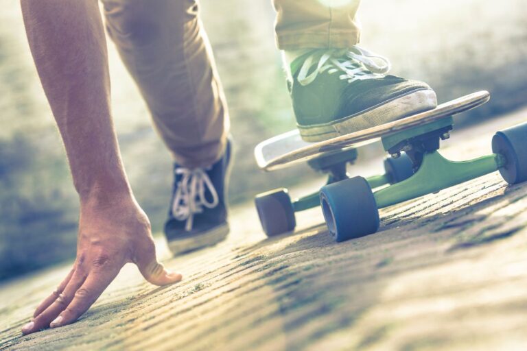 A man sprinting with his skate board.