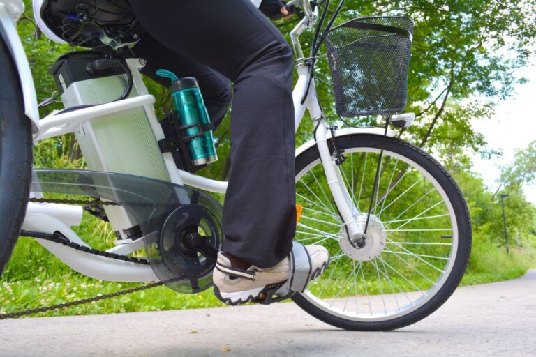 A person biking using an electric bike with front basket.
