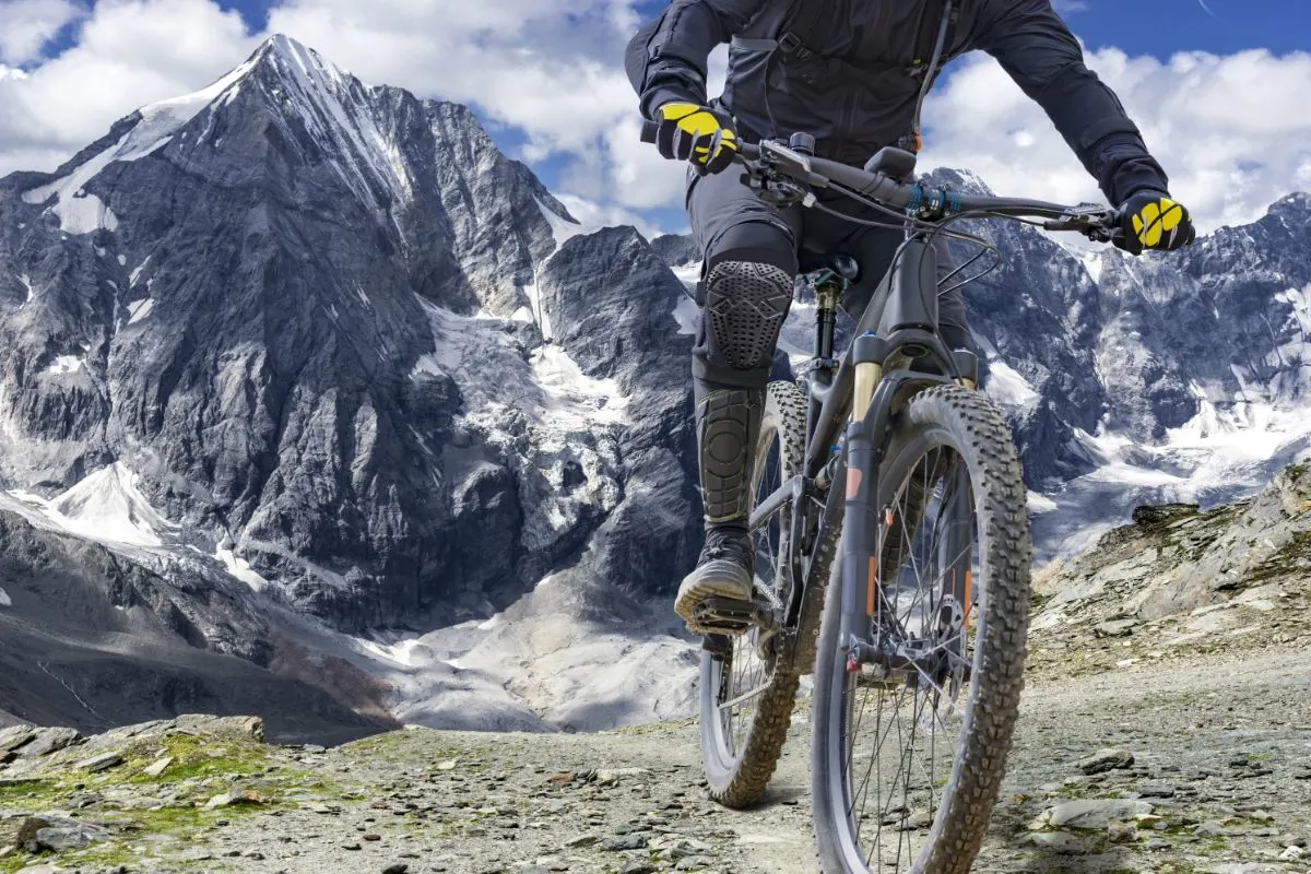 A man biking on an icy mountain train.