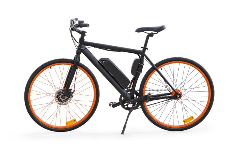 An electric mountain bike with orange wheels.