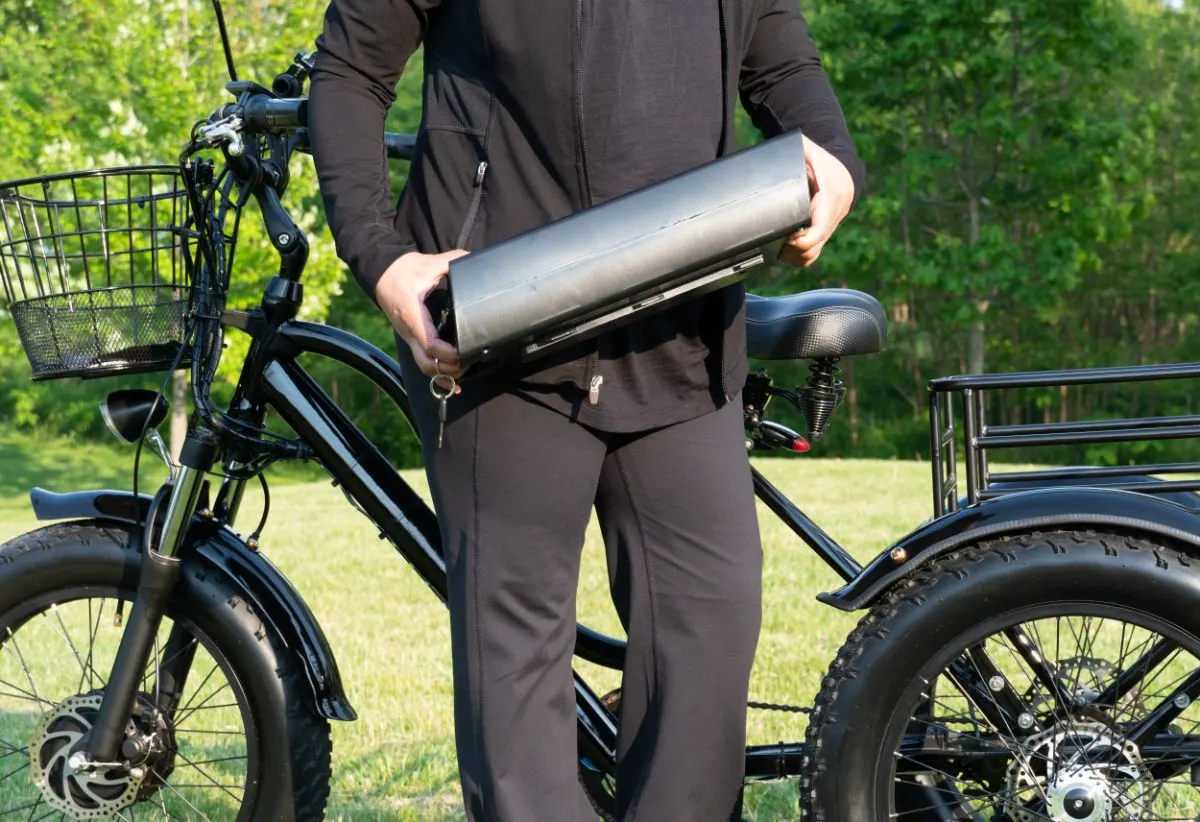 A man holding an electric bike battery.
