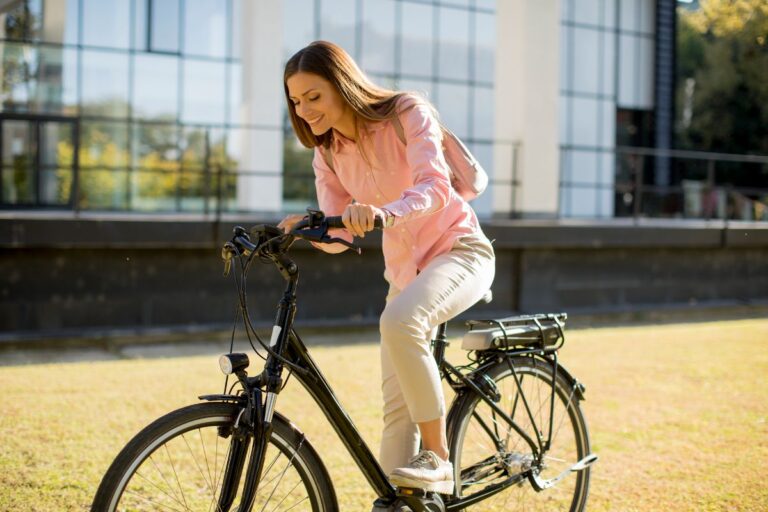 A woman riding her E-bike on the lawn.