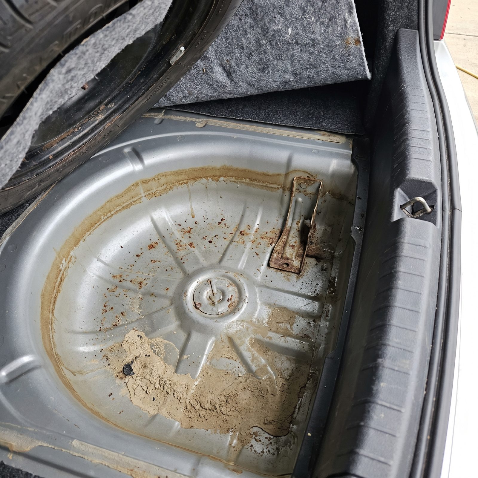 A Waterline Ringed in the Spare-Wheel Well: Hidden Staining From a Chronic Leak or Past Flood