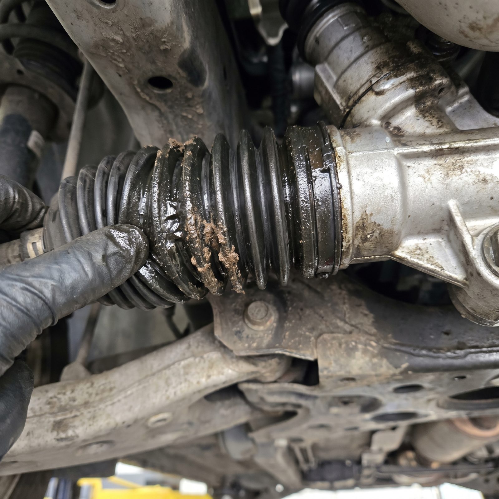 Wet, Grease-Caked Boots on the Steering Rack